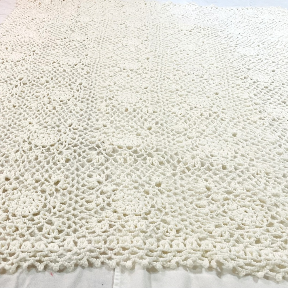 Handmade white crocheted blanket.